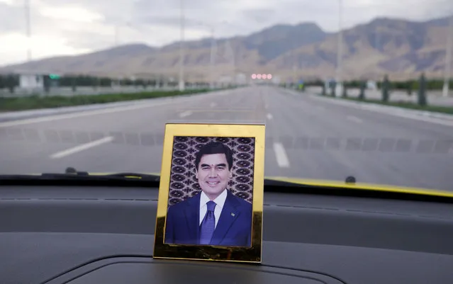 A portrait of the current president Gurbanguly Berdimuhamedow on a dashboard of a taxi. The former dentist took over the presidency after the death of Niyazov in 2006. Most of the bizarre excesses of his predecessor were swiftly rolled back, but on civil liberties and human rights, he's in less of a rush, telling a reporter “never run to where you can simply walk”. (Photo by Amos Chapple via The Atlantic)