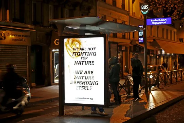 A poster by street artist Climate Games as part of the "Brandalism" project is displayed at a bus stop in Paris, France, November 28, 2015, ahead of the United Nations COP21 Climate Change conference in Paris. (Photo by Benoit Tessier/Reuters)
