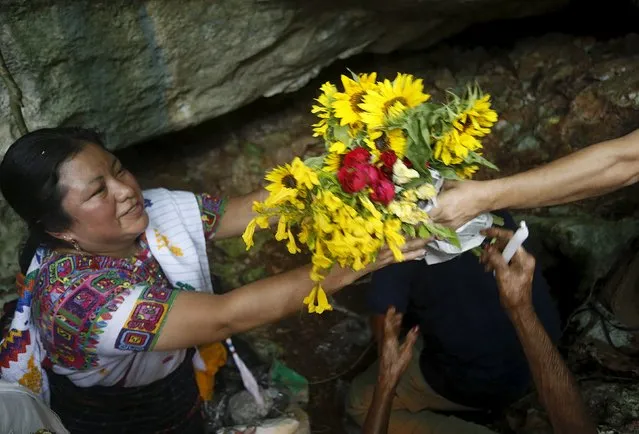 Mayan spiritual leader Juana Justa Yax Tale, from Guatemala, (L), puts flowers at a ceremonial site before a ceremony in honor of Mayan ancestors in Madruga, Cuba, December 8, 2015. (Photo by Reuters/Stringer)