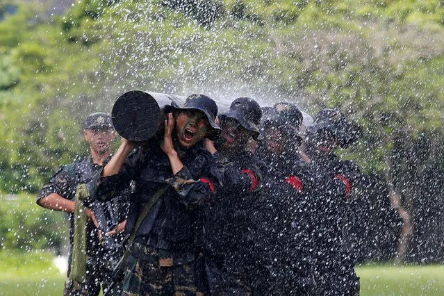 People's Liberation Army soldiers perform at an airbase in Hong Kong, China June 30, 2018, a day before the 21st anniversary of the city's return to Chinese sovereignty from British rule. (Photo by Bobby Yip/Reuters)