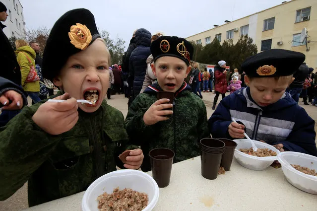 Children have meals during Marines Day celebration in the Black Sea port of Sevastopol, Crimea, November 27, 2016. (Photo by Pavel Rebrov/Reuters)