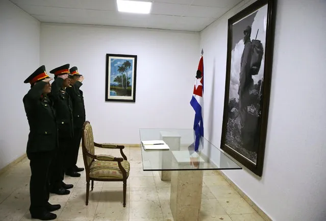 Vietnam's Colonel Major Ta Van Phang (C), Colonel Major Tran Hong Hoa (L) and Major Bui Xuan Phong pay their respects to late Cuban revolutionary leader Fidel Castro at the Cuban Embassy in Madrid, Spain November 28, 2016. (Photo by Andrea Comas/Reuters)