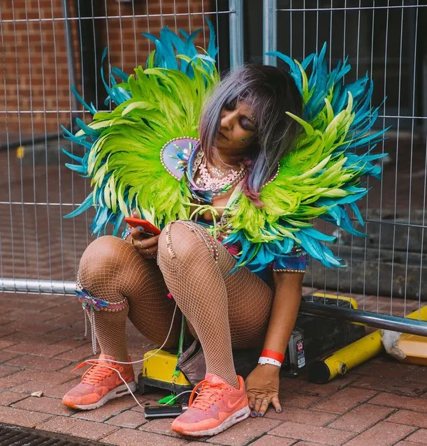 A dancer takes a break at Notting Hill Carnival in London, Britain on August 27, 2018. (Photo by Ben Perry/Rex Features/Shutterstock)