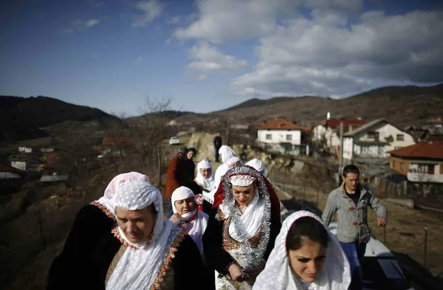 Guests arrive for the wedding ceremony of Bulgarian Muslims Azim Liumankov and his bride Fikrie Bindzheva (not pictured) in the village of Ribnovo, in the Rhodope Mountains, February 15, 2015. (Photo by Stoyan Nenov/Reuters)
