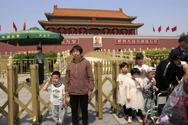 A child makes a gesture and winks as he poses for photos in front of Tiananmen Gate in Beijing on May 3, 2021. China’s population growth is falling closer to zero as fewer couples have children, the government announced Tuesday, May 11, 2021, adding to strains on an aging society with a shrinking workforce. (Photo by Ng Han Guan/AP Photo)