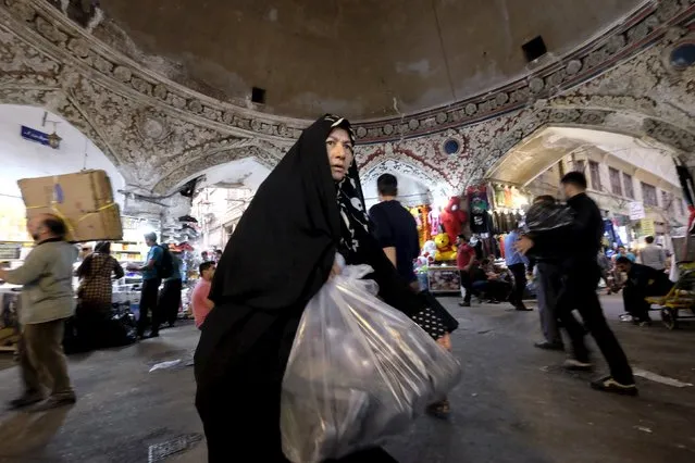 A woman walks with her purchased goods at the grand  Bazar in central Tehran October 7, 2015. (Photo by Raheb Homavandi/Reuters/TIMA)