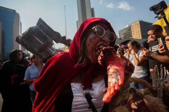 A woman dressed as a zombie gestures during the annual Zombie Walk in Mexico City, Mexico on October 21, 2023. (Photo by Quetzalli Nicte-Ha/Reuters)