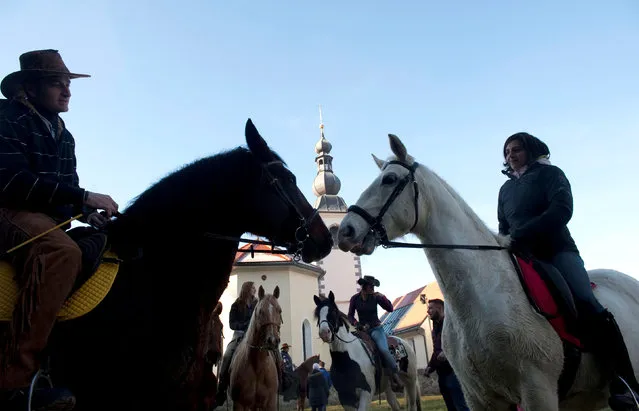 Riders wait for their horses to be blessed by a priest on St. Stephen's day in Srednja Vas, Slovenia December 26, 2016. (Photo by Srdjan Zivulovic/Reuters)