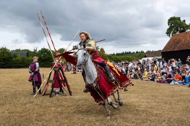 A re enactor as an armoured knight brings to life the scenes from the time of Henry VIII during a medieval jousting tournament at Chiltern Open Air Museum, United Kingdom on August 21, 2022. The museum tells the story of the Chilterns area through the preservation of historic buildings, landscapes and culture. (Photo by Stephen Chung/Alamy Live News)