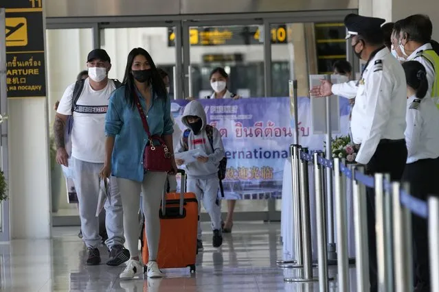 The first group of tourists arrive on an Etihad flight from Abu Dhabi at the Phuket International Airport in Phuket, Thailand, Thursday, July 1, 2021. Starting Thursday, Thailand is welcoming back international visitors — as long as they are vaccinated — to its famous southern resort island of Phuket without having to be cooped up in a hotel room for a 14-day quarantine. (Photo by Sakchai Lalit/AP Photo)