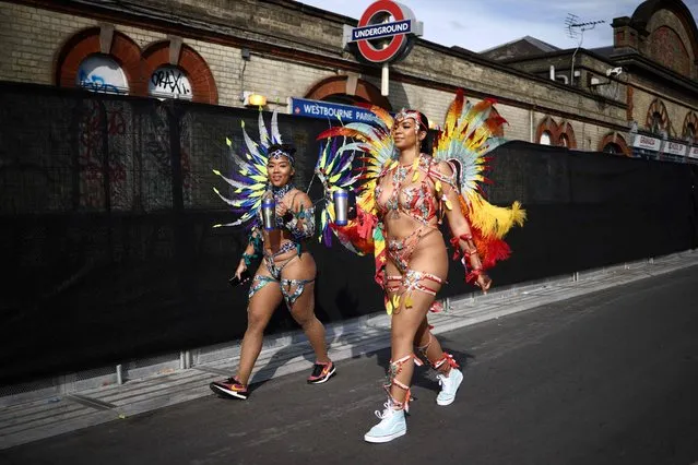 Performers in costume arrive to take part in the main Parade Day of the Notting Hill Carnival in west London on August 27, 2023. (Photo by Henry Nicholls/AFP Photo)