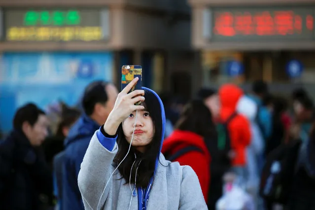A passenger takes picture of herself at the Beijing Railway Station in central Beijing, China January 13, 2017 as the annual Spring Festival travel rush begins ahead of the Chinese Lunar New Year. (Photo by Damir Sagolj/Reuters)