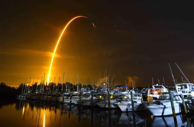 This long exposure photo shows the launch of a SpaceX Falcon 9 rocket on a resupply mission for NASA to the International Space Station from Pad 39A at Kennedy Space Center, seen from Merritt Island, Fla., Sunday, August 29, 2021. The SpaceX shipment of ants, avocados and a human-sized robotic arm rocketed toward the International Space Station on Sunday. (Photo by Malcolm Denemark/Florida Today via AP Photo)