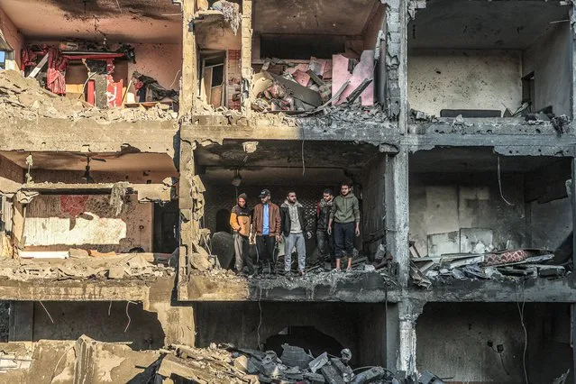 Palestinians check a half destroyed building following Israeli bombardment on Rafah, in the southern Gaza Strip, on December 15, 2023, amid continuing battles between Israel and the Palestinian militant group Hamas. (Photo by Said Khatib/AFP Photo)
