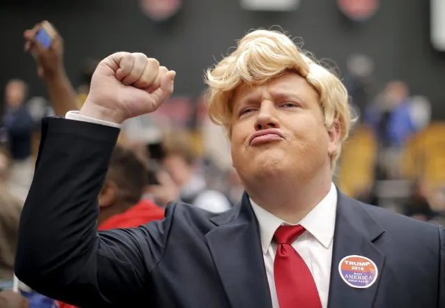 Supporter Forrest Surber dressed as U.S. Republican presidential candidate Donald Trump pumps his first before a campaign event in Radford, Virginia February 29, 2016. (Photo by Chris Keane/Reuters)