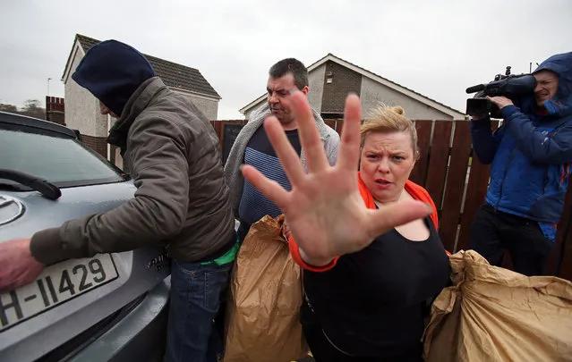 Seamus Daly (2L) walks to a car after being released from Maghaberry prison near Belfast, Northern Ireland on March 1, 2016. A British court dropped all charges against Daly, the only remaining suspect in Northern Ireland's 1998 Omagh bombing that killed 29 people and threatened a peace deal in the province. (Photo by Paul Faith/AFP Photo)