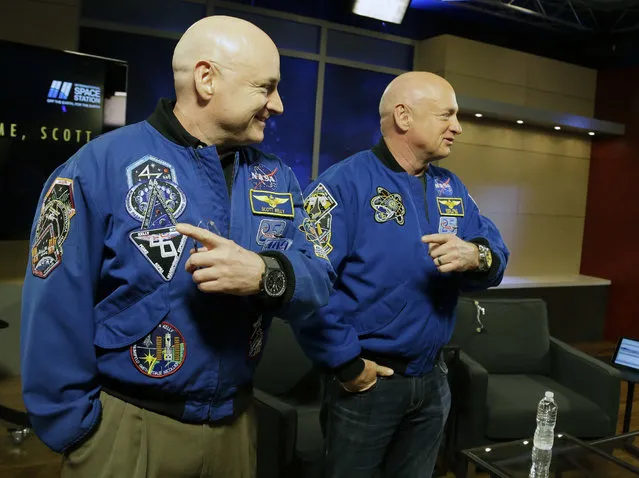 NASA astronaut Scott Kelly, left, and his twin Mark get together before a news conference Friday, March 4, 2016, in Houston. Scott Kelly set a U.S. record with his a 340-day mission to the International Space Station. (Photo by Pat Sullivan/AP Photo)