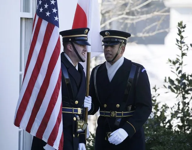 U.S. Marines stand with U.S. and Japanese flags prior to the arrival of Japanese Prime Minister Shinzo Abe at the White House in Washington, U.S., February 10, 2017. (Photo by Jim Bourg/Reuters)