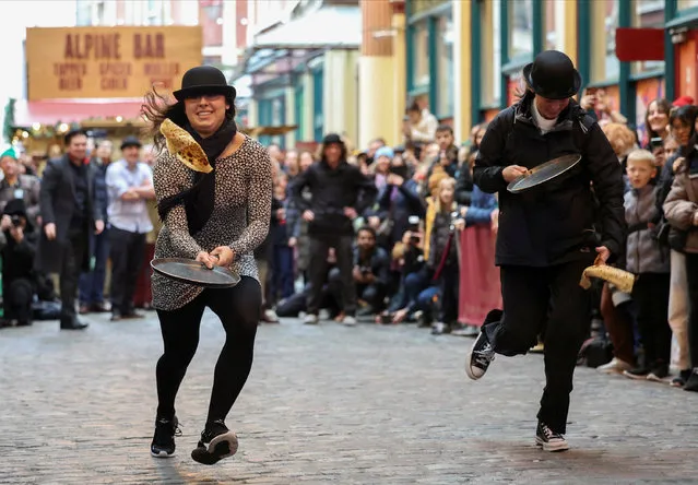 Competitors take part in the Shrove Tuesday Pancake Race at the City of London's Leadenhall Market on February 13, 2024. (Photo by Isabel Infantes/Reuters)