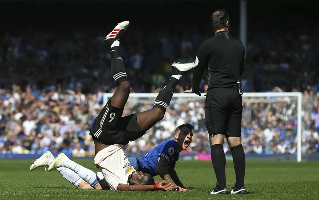 Everton's Lucas Digne, center, clashes with Manchester United's Paul Pogba during the English Premier League soccer match at Goodison Park, Liverpool, England, Sunday April 21, 2019. (Photo by Martin Rickett/PA Wire via AP Photo)