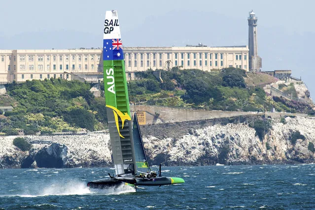 Australia's SailGP team passes Alcatraz while practicing on Tuesday, April 30, 2019, in San Francisco. The F50 foiling catamarans, which organizers say can reach 60 miles per hour, will compete on the San Francisco Bay May 4-5. (Photo by Noah Berger/AP Photo)