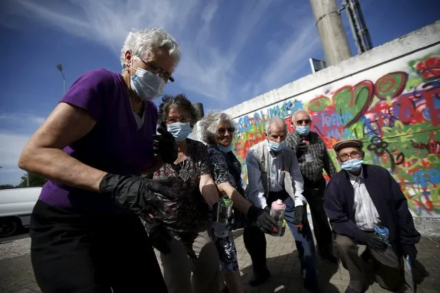 Participants pose at the end of a graffiti class offered by the LATA 65 organization in Lisbon, Portugal May 14, 2015. (Photo by Rafael Marchante/Reuters)