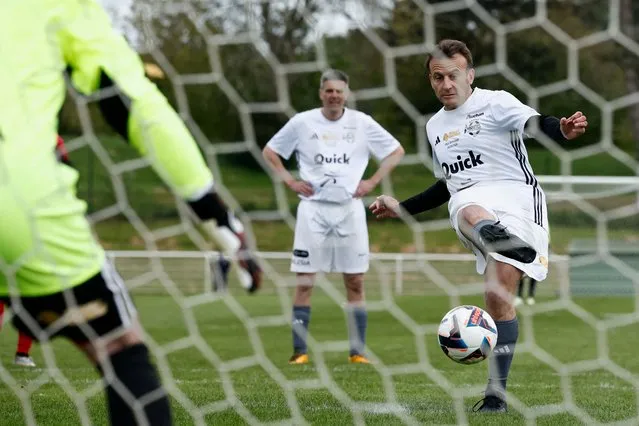 French President Emmanuel Macron scores a penalty as he participates in the Varietes Club charity football match to benefit children in hospital, in Bernard Giroux stadium in Plaisir, outside Paris, France, on April 24, 2024. (Photo by Benoit Tessier/Pool via Reuters)