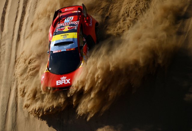 French driver Sebastien Loeb and co-driver Fabian Lurquin of Belgium compete during the Stage 1A of the Dakar Rally 2022 between Jeddah and Hail, in Saudi Arabia, on January 1, 2022. (Photo by Franck Fife/AFP Photo)