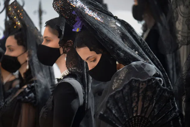 Models dressed in the typical Mantilla lace walk through the centre of Seville on March 26, 2021 ahead of the Holy Week whose rituals and processions have been affected by the coronavirus pandemic. (Photo by Cristina Quicler/AFP Photo)