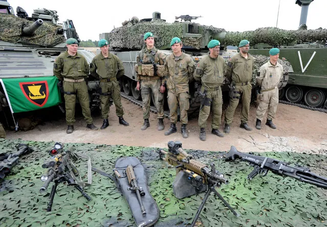 Norwegian soldiers stand next to their gear after the NATO Noble Jump exercise on a training range near Swietoszow Zagan, Poland, Thursday, June 18, 2015. (AP Photo/Alik Keplicz)