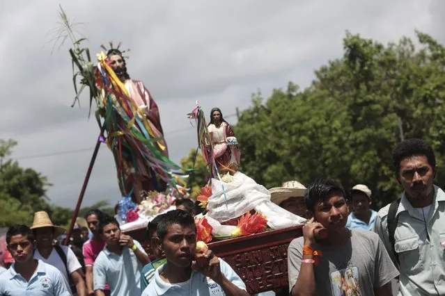 Devotees carry images of San Juan Bautista during a procession at San Juan de Oriente town, Nicaragua, June 26,2015. (Photo by Oswaldo Rivas/Reuters)