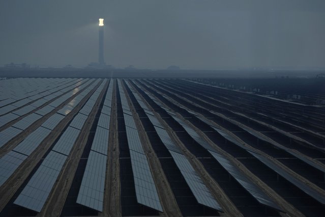 A solar tower and panels operate at Mohammed bin Rashid Al Maktoum Solar Park as Dubai, United Arab Emirates hosts the COP28 U.N. Climate Summit, Monday, December 11, 2023, in Dubai, United Arab Emirates. The world's renewable energy grew at its fastest rate in the past 25 years in 2023, the International Energy Agency reported Thursday, Jan. 11, 2024. (Photo by Joshua A. Bickel/AP Photo)