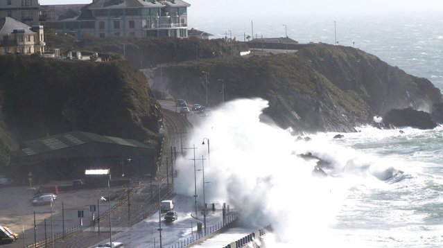 Waves crash over cars along the Promenade coastal road as Storm Kathleen makes its way through the British Isles, in Douglas, Isle of Man in this screen grab obtained from social media video on April 8, 2024. (Photo by Wild Enthusiasm via Reuters)