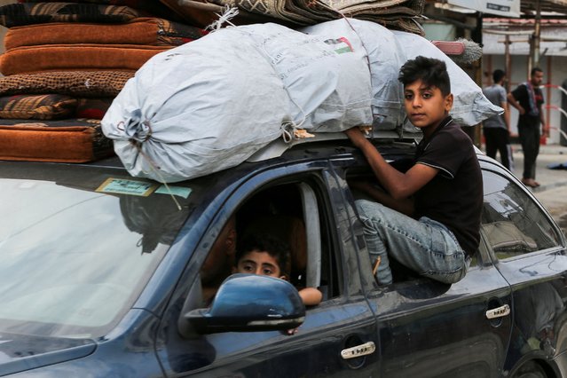 Palestinians travel in a vehicle loaded with their belongings as they flee Rafah due to an Israeli military operation, in Rafah, in the southern Gaza Strip, on May 28, 2024. (Photo by Hatem Khaled/Reuters)