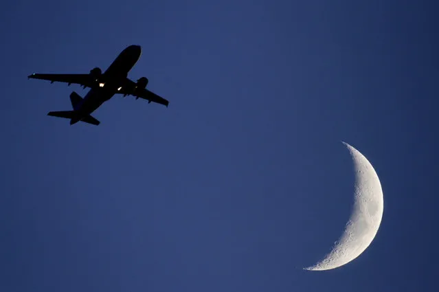 In this file photo dated Wednesday June 16, 2010, a plane takes off into the night sky from London's Heathrow Airport. Three airliners narrowly missed colliding with drones near London's Heathrow Airport in the space of three weeks last year, according to a report released Friday March 31, 2017, by the U.K. Airprox Board organisation which catalogs air safety incidents, underscoring increasing concerns about the drone devices proximity to aircraft. (Photo by Odd Andersen/AP Photo)