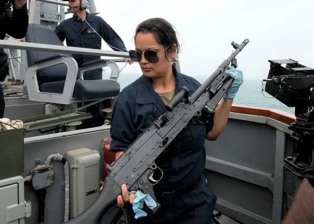 US Navy sailor of the destroyer USS Ross, Christina Cortez from Sant Diego, California, prepares a machine gun, during Sea Breeze 2021 maneuvers, in the Black Sea, Wednesday, July 7, 2021. Ukraine and NATO have conducted Black Sea drills involving dozens of warships in a two-week show of their strong defense ties and capability following a confrontation between Russia's military forces and a British destroyer off Crimea last month. (Photo by Efrem Lukatsky/AP Photo)