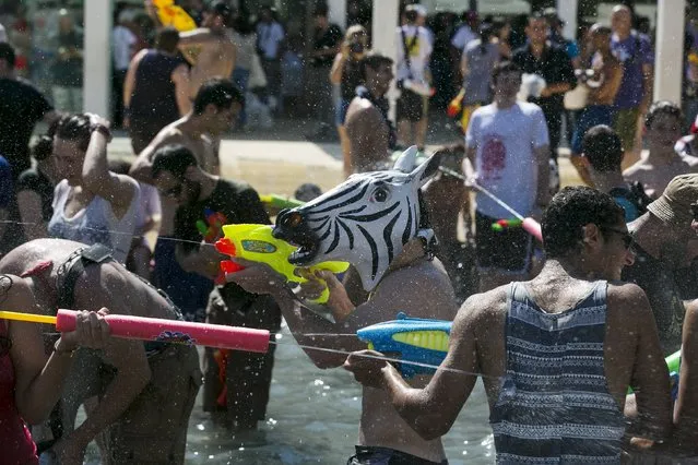 A man wearing a zebra mask participates in a water fight in Tel Aviv, July 10, 2015. (Photo by Baz Ratner/Reuters)