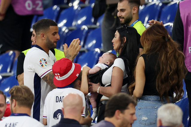 Kyle Walker of England interacts with his child and his wife Annie Kilner after the UEFA EURO 2024 round of 16 match between England and Slovakia at Arena AufSchalke on June 30, 2024 in Gelsenkirchen, Germany. (Photo by Richard Pelham/Getty Images)