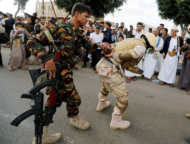 Houthi militants perform the scene depicting a fake detention of a U.S. soldier during a demonstration against the U.S. intervention in Yemen, in the country's capital Sanaa, May 13, 2016. (Photo by Khaled Abdullah/Reuters)