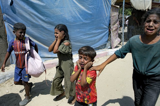 Palestinian children are evacuated from a site hit by an Israeli bombardment on Khan Younis, southern Gaza Strip, Saturday, July 13, 2024. Israel said it targeted Hamas' shadowy military commander in a massive strike Saturday in the crowded southern Gaza Strip that killed at least 71 people, according to local health officials. Hamas immediately rejected the claim that Mohammed Deif was targeted. (Photo by Jehad Alshrafi/AP Photo)