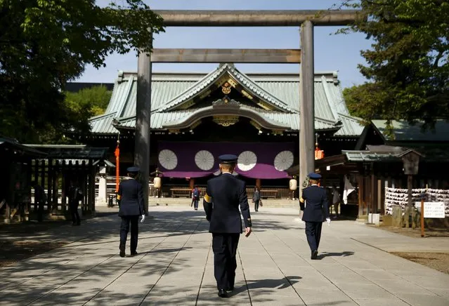 Shrine security officials walk in the precincts of the Yasukuni shrine during the visit of a group of Japanese lawmakers in Tokyo, Japan April 22, 2016. (Photo by Thomas Peter/Reuters)