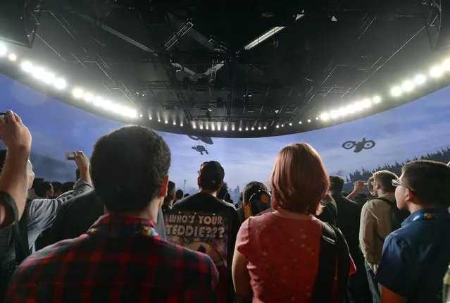 Attendees watch a trailer of the new multiplayer action game "Call of Duty: Advanced Warfare" in the Activision booth at the 2014 Electronic Entertainment Expo, known as E3, in Los Angeles, June 10, 2014. REUTERS/Kevork Djansezian