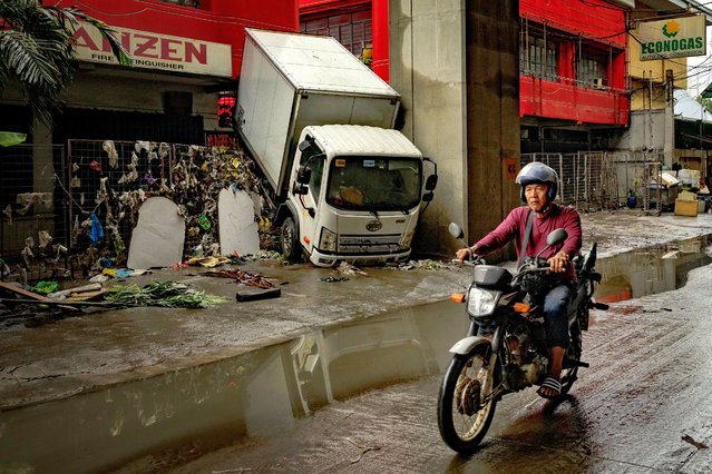 A truck swept by floodwaters brought about by Typhoon Gaemi is seen on July 25, 2024 in Quezon city, Metro Manila, Philippines. Monsoon rains, intensified by Typhoon Gaemi, have caused flooding and landslides throughout the Philippines, resulting in at least 22 deaths and displacing over 600,000 people. The typhoon, which also left two dead in Taiwan, did not make landfall in the Philippines but enhanced monsoon rains. In the region around the capital Manila, government work and schools were suspended due to severe overnight flooding. (Photo by Ezra Acayan/Getty Images)