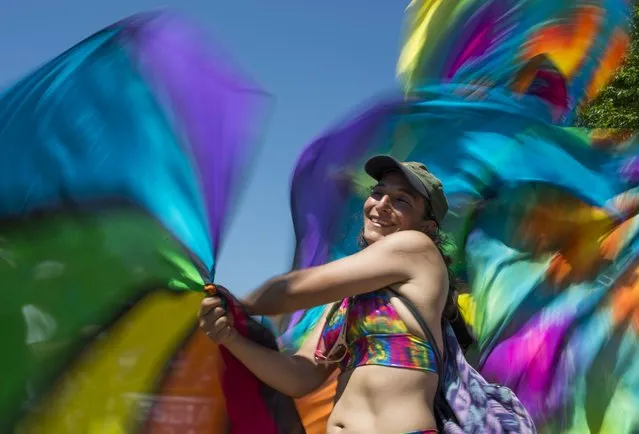 A woman spins rainbow flags as she takes part in the Equality March for Unity & Pride parade in Washington DC, June 11, 2017. (Photo by Andrew Caballero-Reynolds/AFP Photo)