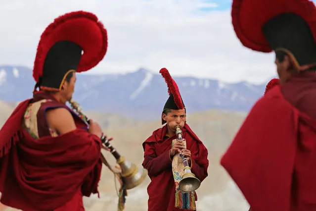 Monks play music and perform Buddhist ceremonies outside of the city gates during the Tenchi Festival on May 27, 2014 in Lo Manthang, Nepal. The Tenchi Festival takes place annually in Lo Manthang, the capital of Upper Mustang and the former Tibetan Kingdom of Lo. Each spring, monks perform ceremonies, rites, and dances during the Tenchi Festival to dispel evils and demons from the former kingdom. (Photo by Taylor Weidman/Getty Images)