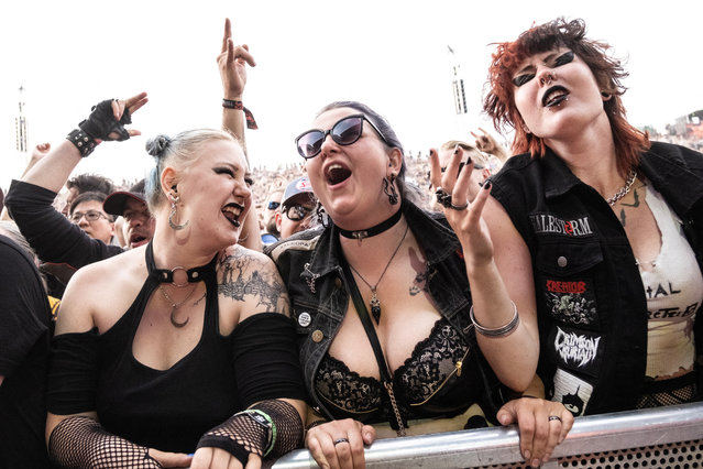 Spectators react during the performance of US rock band Halestorm with lead vocalist and guitarist Lzzy Hale during the heavy metal music Festival Copenhell, in Copenhagen, Denmark, on June 15, 2023. (Photo by Helle Arensbak/Ritzau Scanpix via AFP Photo)