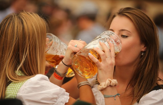 Young women enjoy drinking beer out of 1-liter-mugs of beer during the opening weekend of the 2019 Oktoberfest on September 21, 2019 in Munich, Germany. This year's Oktoberfest, which will draw millions of visitors from all over the world, will run from October 21 through October 6. (Photo by Johannes Simon/Getty Images)