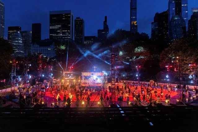 People roller skate at the DiscOasis during the opening night at Central Park in New York City, U.S., June 18, 2022. (Photo by Jeenah Moon/Reuters)