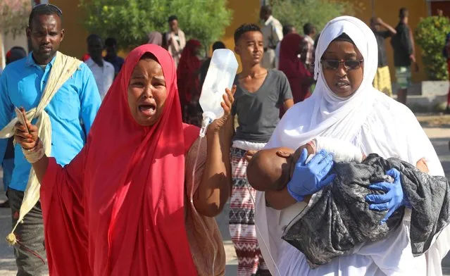 A woman reacts as an injured child is assisted at the Madina hospital following a car bomb explosion at a checkpoint in Mogadishu, Somalia December 28, 2019. Islamist group al Shabaab claimed responsibility for the bomb blast that killed at least 90 people while Somalia said a foreign government that it did not identify helped plan the attack. The bombing was the deadliest in more than two years in a country wrecked by nearly three decades of Islamist violence and clan warfare. (Photo by Feisal Omar/Reuters)