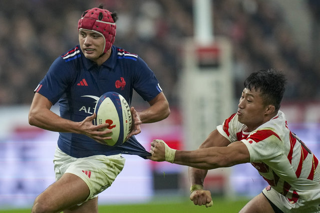 Japan's Tomoki Osada tries to pull back France's Louis Bielle-Biarrey during the Autumn Nations series rugby union match between France and Japan at the Stade de France in Saint-Denis, outside Paris, Saturday, November 9, 2024. (Photo by Christophe Ena/AP Photo)